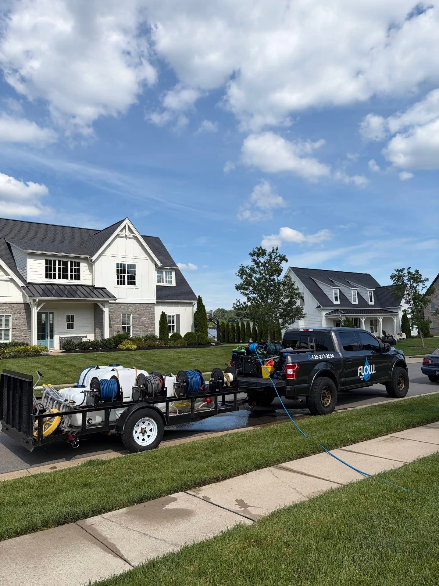 Flow HomeCare truck and equipment trailer parked outside a Middle Tennessee home